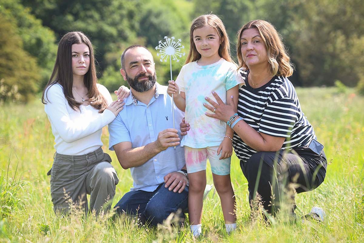 Luca Atzori and his family pose for photo in a field