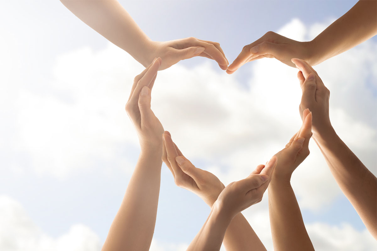 Symbol and shape of heart created from hands.The concept of unity, cooperation, partnership, teamwork and charity.