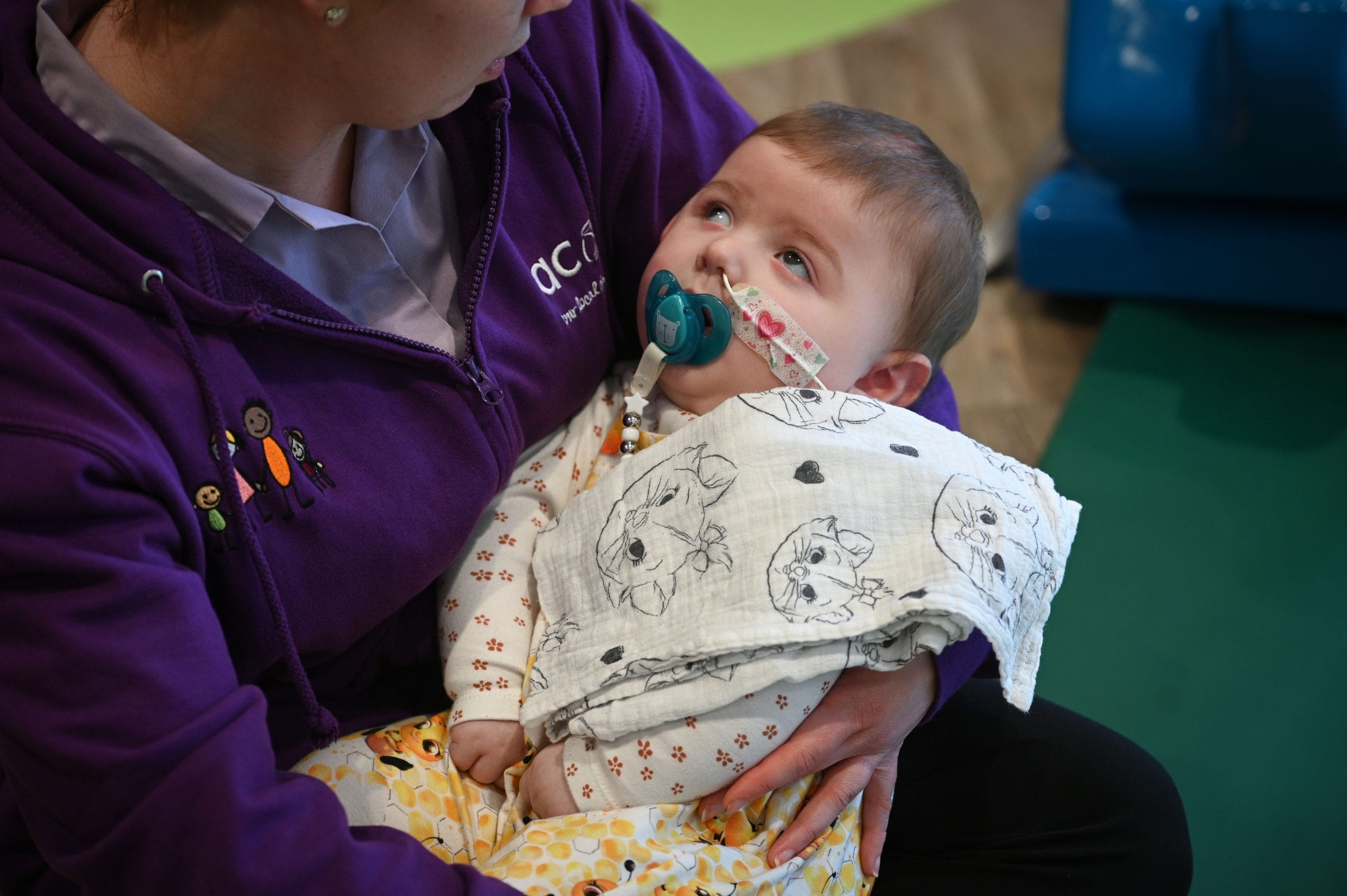 Acorns staff holding a baby