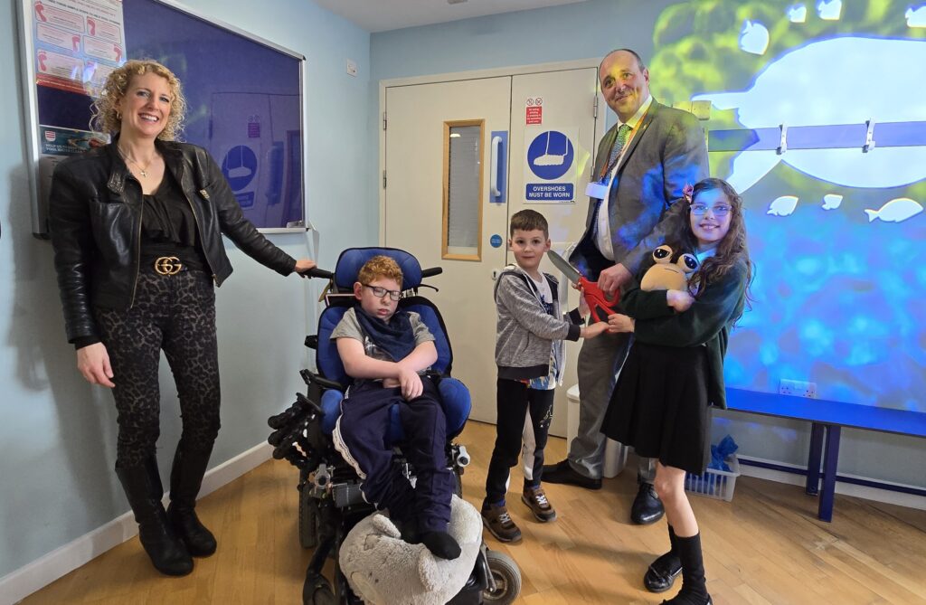 Trevor Johnson, Chief Executive of Acorns at the opening with Catherine Atkins, and her children Jack, Oliver and Maisie.