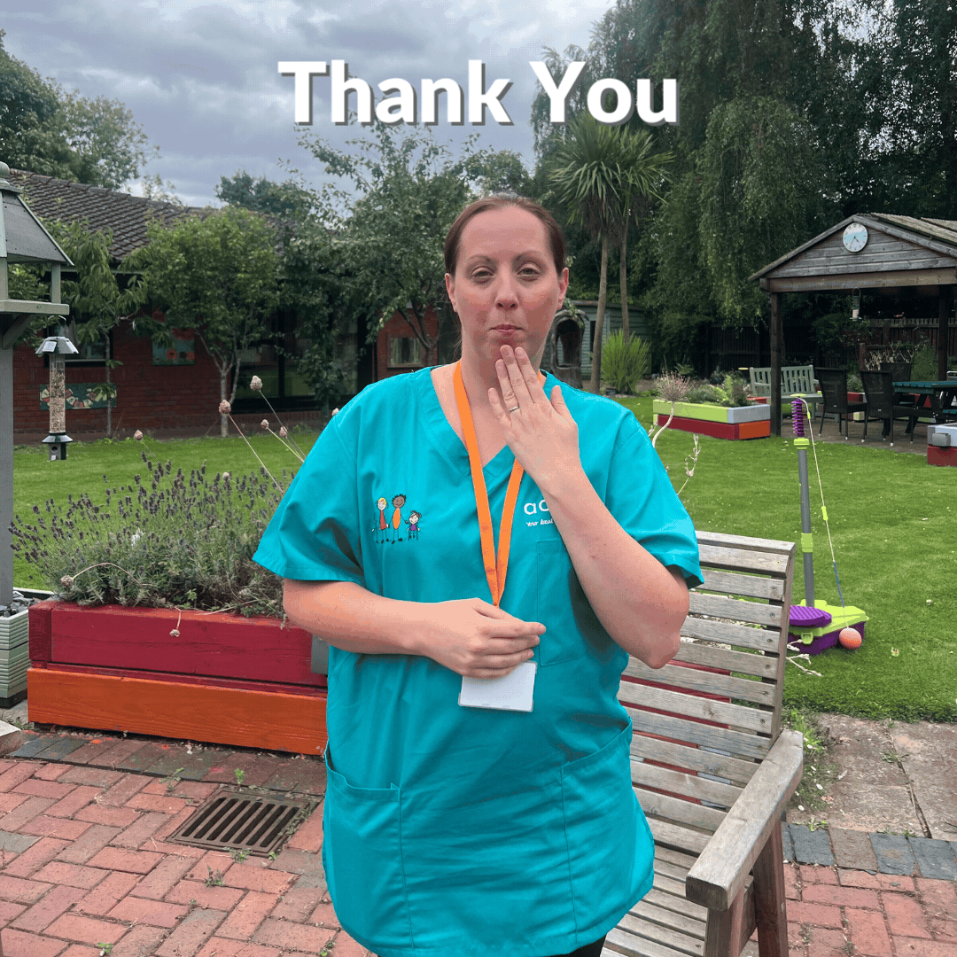 A nurse signing Thank You in Makaton.
