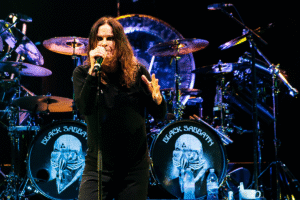 Ozzy Osborne singing on stage with his band Black Sabbath