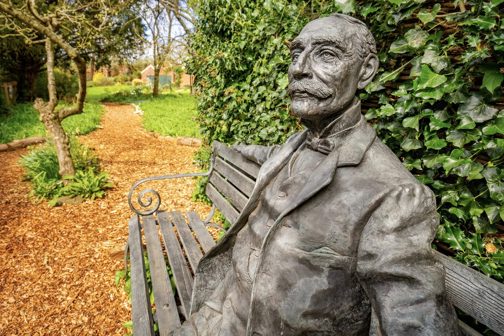 Statue of Sir Edward Elgar seated on a bench in the garden of The Firs, Elgar’s Birthplace Museum