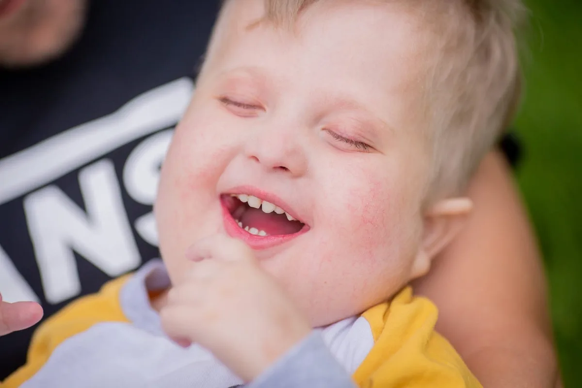 A close up of a little boy smiling