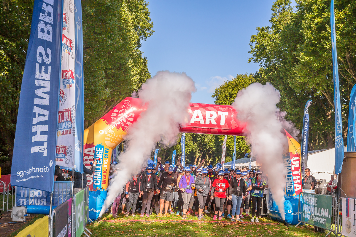 An inflatable race start arch with participants waiting underneath.