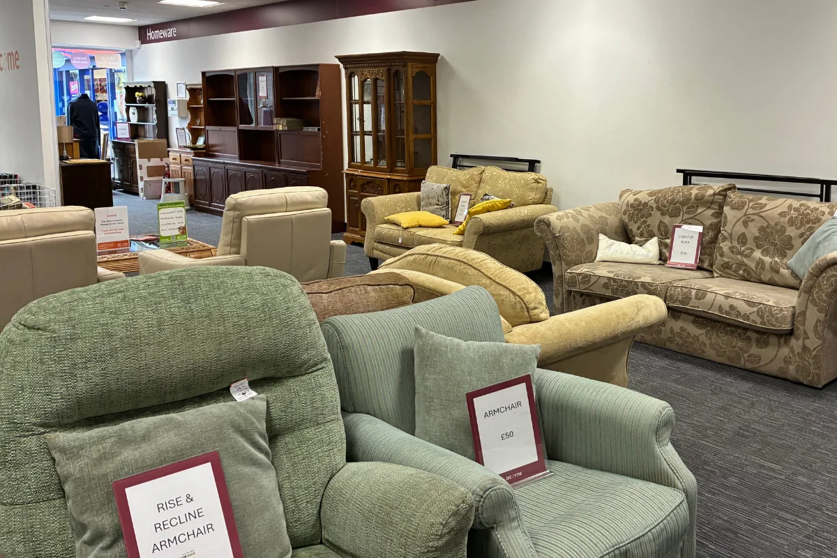 Furniture donations being received at an Acorns charity shop.