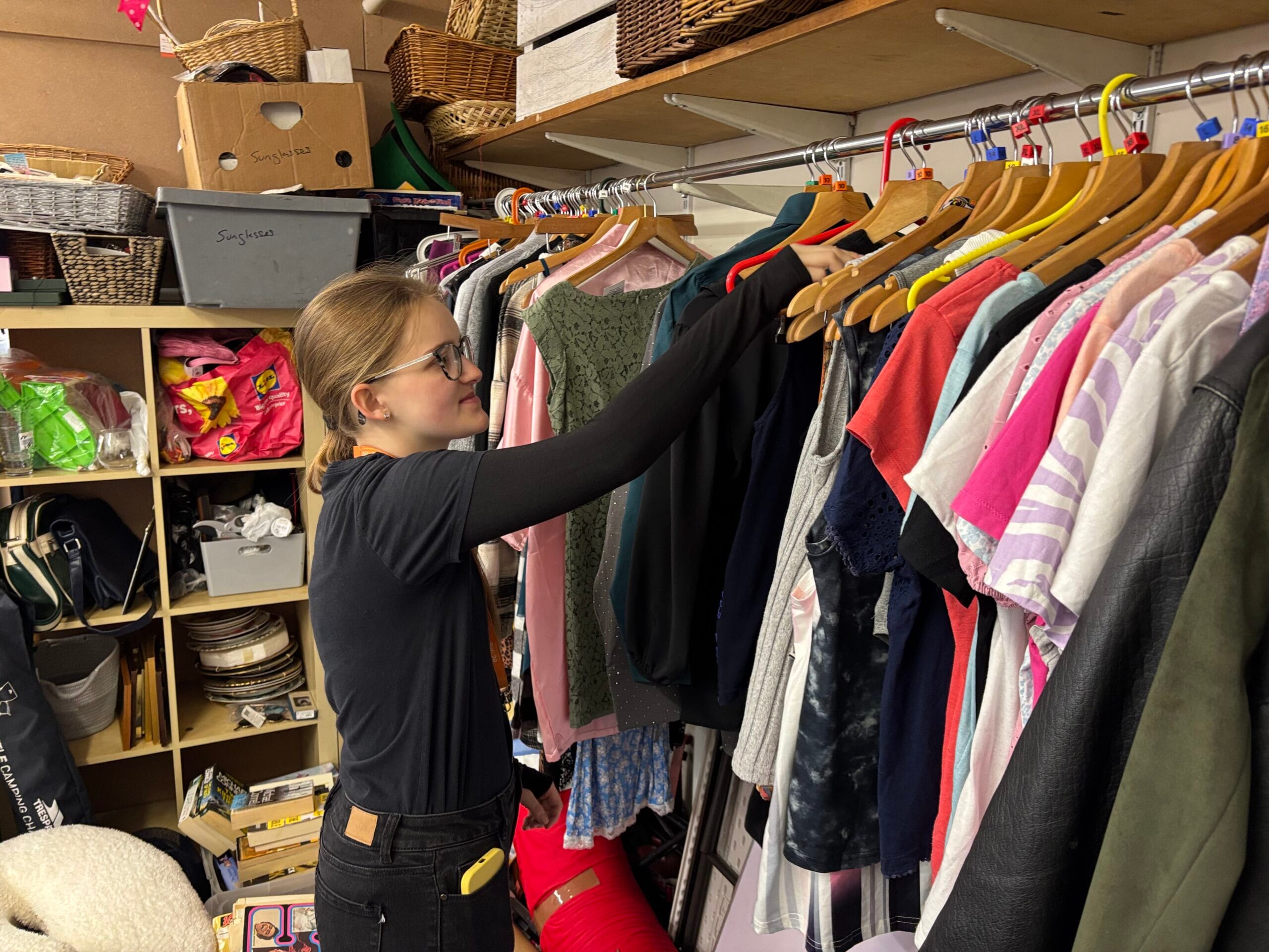 Young volunteer gaining retail experience in an Acorns charity store