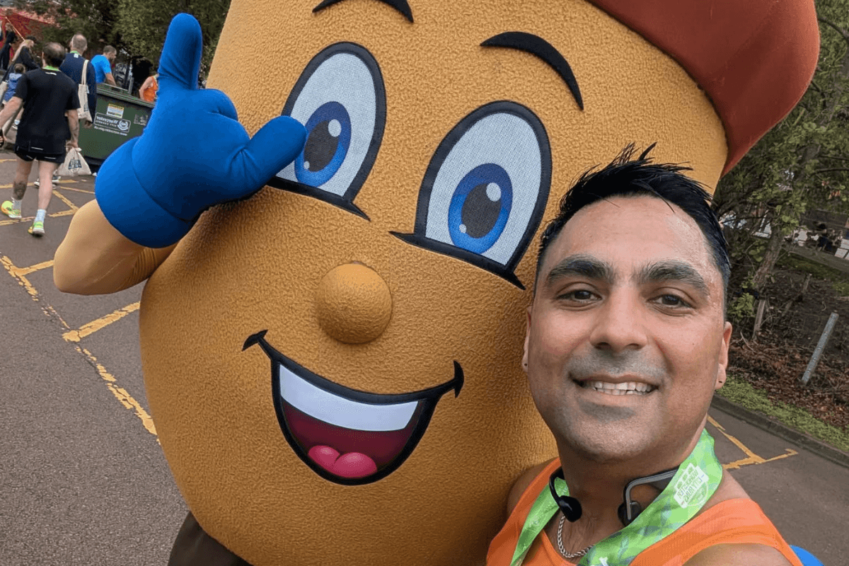 WCR 27 A close up selfie of a man and an Acorns mascot.