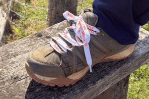 Acorns laces A close up of a hiking shoe that has white laces with Acorns logo on.