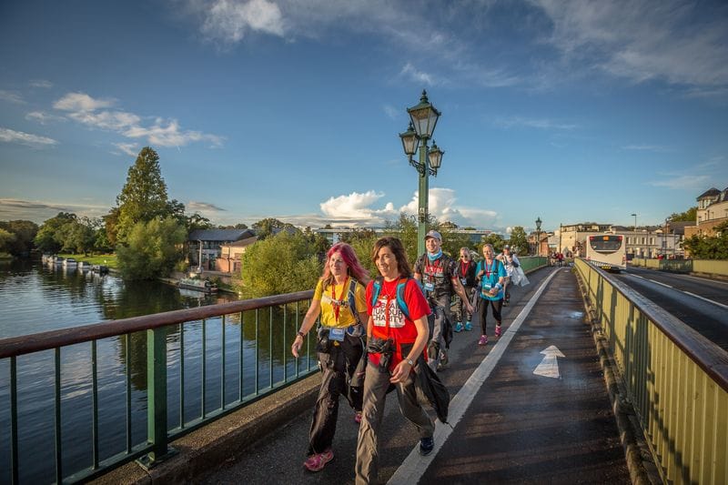 TPC UC bridge Walkers crossing a bridge over the River Thames