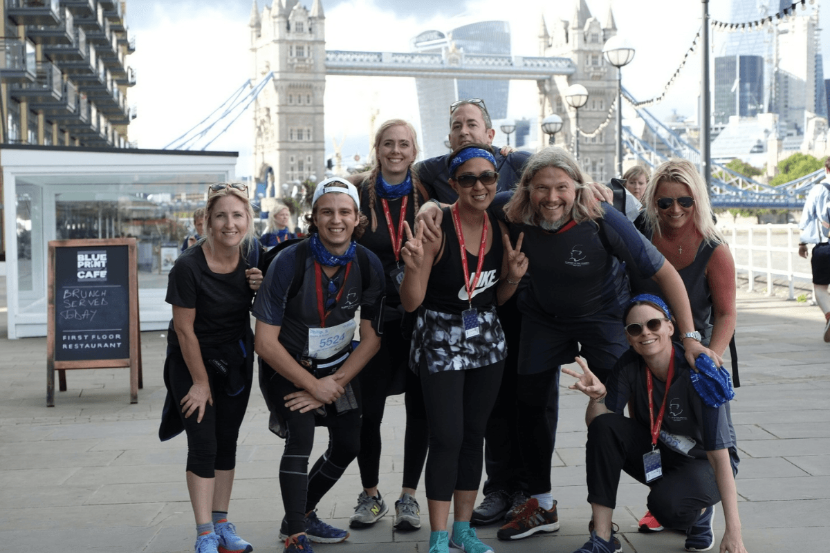 Thames Twilight 10 A group of eight people posing with the London Tower Bridge in the distant background.