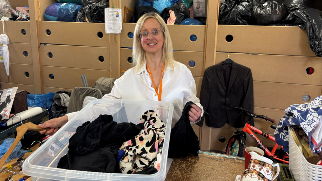 An Acorns Children's Hospice colleague sorting through donated items at its superstore in Walsall.