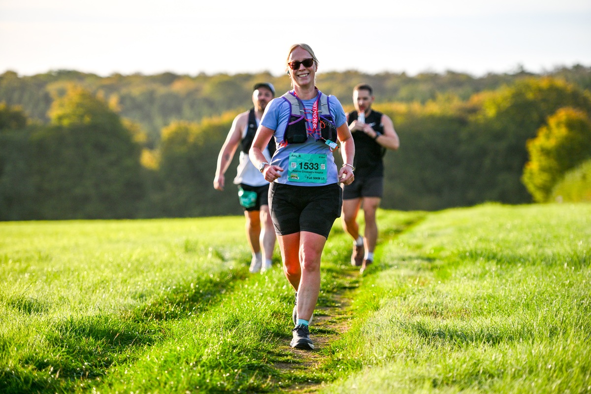 A Chiltern 50 Ultra Challenge participant running through a field
